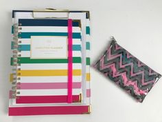 a colorful notebook next to a small pouch