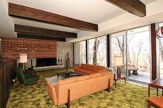 a living room filled with furniture and a fire place next to a sliding glass door