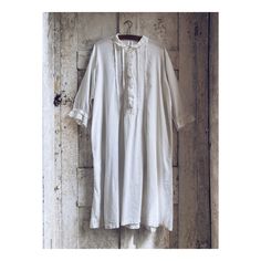 Antique French White Fine Cotton Nightdress from around 1920.  This piece is a simple classic design. It has pleats sewn in to the front and back to give it body. It is made from a very fine soft cotton with long sleeves, buttons down the front and a collar. There is a decorative trim around the collar, sleeves and buttons. It has all its original shell buttons.  Condition - It is in good condition.  Please Note:  - The pleats at the back have two little tears, this is not very noticeable, but m White Cotton Nightgown, Dress Night, Style Français, Cotton Nightgown, White Cotton Dress, Mid Length Sleeves, Decorative Trim, Shell Buttons, French Linen