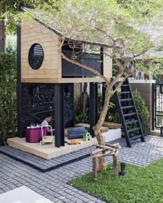 a small house with a tree in the front and stairs leading up to it's roof