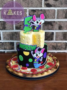 a three tiered cake decorated with cartoon characters