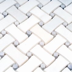 a close up view of white and gray tiles