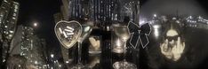 a couple of wine glasses sitting on top of a table in front of a cityscape