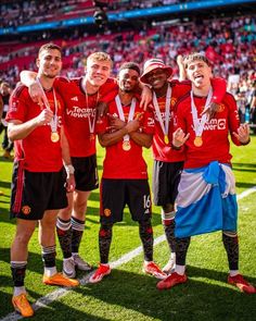 the manchester united team celebrates with their trophy