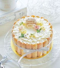 a wedding anniversary cake on a plate with silverware and napkins next to it