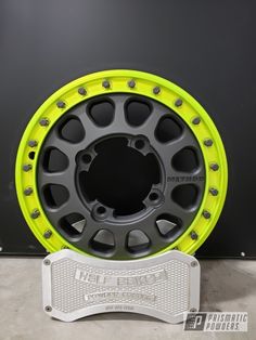 an image of a wheel that is yellow and grey with black spokes on it