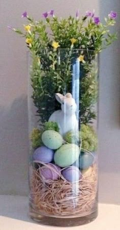 a glass vase filled with eggs and flowers