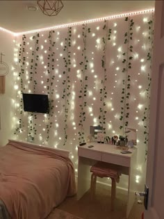 a bed room with a neatly made bed and lights on the wall