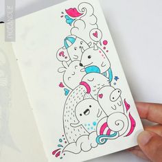 a hand holding up a card with some drawings on it