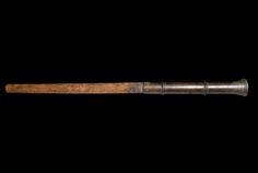 an old wooden baseball bat on a black background