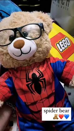 a teddy bear wearing glasses and a spider suit