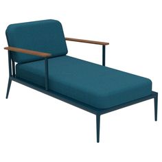 a blue chaise lounge chair with wooden arms and back rests against a white background