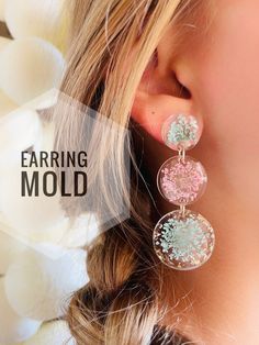 the earring mold is made from glass and has pink, blue and white flowers on it