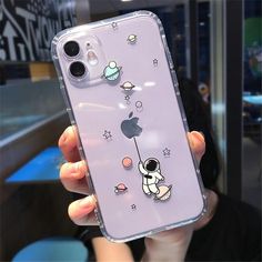 a person holding up an iphone case with cartoon characters on it