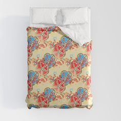 an image of a bed set with flowers and hearts on the comforter cover that has been made