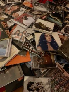 a pile of cds with pictures on them