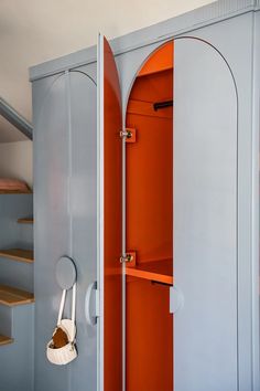 an orange and grey closet with some shelves