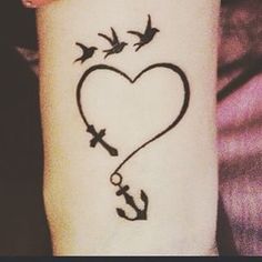 an anchor and heart tattoo on the arm