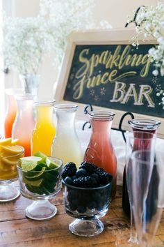 there are many different types of drinks on the table together in front of a sign that says sparkling juice bar