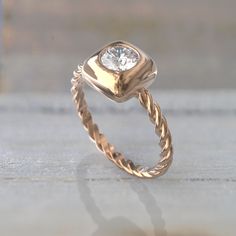 a gold ring with a diamond in the center