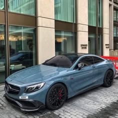 a blue car parked in front of a building