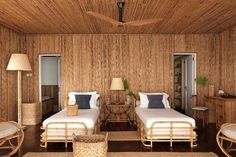 two beds in a room with wood paneling and wicker decor on the walls