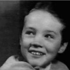 an old photo of a young boy smiling