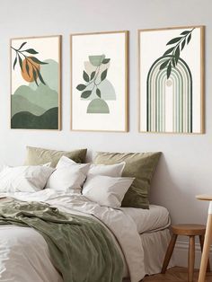 three paintings hang on the wall above a bed