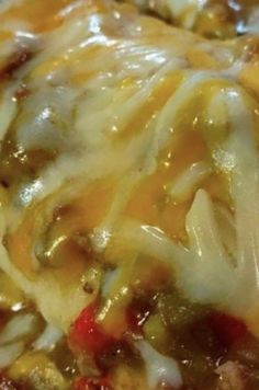 a close up view of some food with cheese and sauce on it's surface