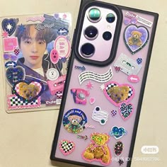 an iphone case with stickers on it next to a card and magnets in the shape of hearts