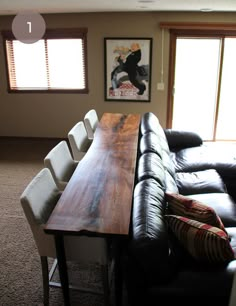 a living room with couches and a wooden table in it's center area