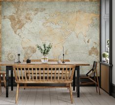 a dining room table with chairs and a map on the wall