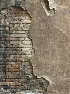 an old brick wall that has been torn down and is being used as a background