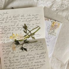 two old letters with flowers on them are laying next to an envelope that has been written