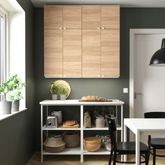 a kitchen with green walls and wooden cabinets