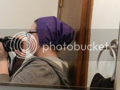 a person taking a photo in front of a mirror with a camera on their head