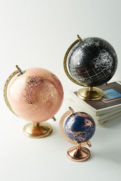 three different globes sitting on top of each other