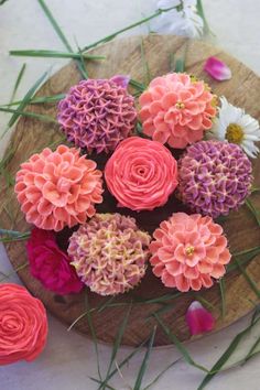 pink and purple flowers in a wooden bowl