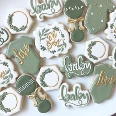 baby shower cookies are arranged on a plate