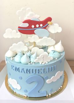 a blue and white cake with a plane on top