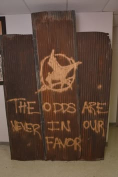 an old wooden sign with graffiti on it that says the odds are never in our favors