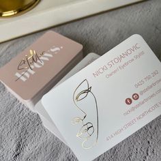 two business cards sitting on top of each other