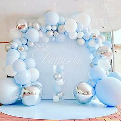 an arch made out of balloons and silver balls