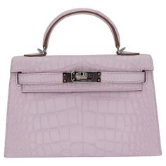 Brand: Hermès Style: Kelly II Sellier Mini Size: 20cm Color: Mauve Pale Material: Matte Alligator Hardware: Palladium Hardware (PHW) Dimensions: 7.5" W x 4.5" H x 2.25" D Handle Drop: 2.5" Strap Drop: 18.5" Most Expensive Handbags, Hermes Style, Hermes Kelly Bag, Gold Aviator Sunglasses, Expensive Handbags, Shopping Photography, Jane Birkin, Iconic Bags, Money Bag