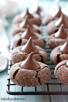 there are many cookies with chocolate frosting on the cooling rack