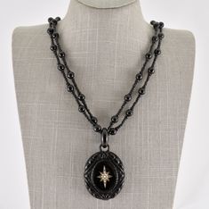 Description  Antique mid Victorian Whitby Jet 9ct gold seed pearl mourning locket & necklace. Beautifully carved Whitby Jet mourning locket inset with a 9ct gold star adorned with seed pearls to the center. Photograph to verso of a Victorian lady. The locket hangs on it's original Whitby Jet double strand beaded necklace having a 9ct bolt ring fastener, the fastener being stamped 9ct. A superb quality piece from the mid Victorian period. With gift box. A fantastic addition to any collection.  Please study the photographs carefully as they form part of the overall description.   Date Mid Victorian Weight 72.07 grams    Dimensions of pendant 55mm x 40mm Necklace: 360mm (As worn) Condition. Excellent condition for it's age. Victorian Locket Necklace, Victorian Jewelry Necklace, Bloodstone Ring, Victorian Jewellery, Victorian Locket, Victorian Necklace, Green Tourmaline Ring, Bolt Ring, Victorian Period