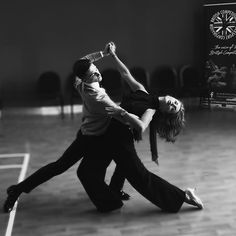 a man and woman dancing on a dance floor