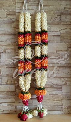 an arrangement of flowers hanging on the wall