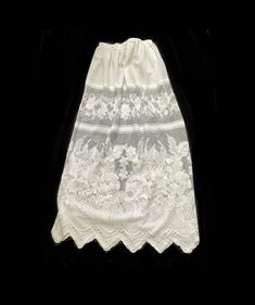 White lace fabric under slip. Sheer fabric Skirt or Slip with adjustable elastic waist. Extra Long Large size Slip measurement  28 inches wide elastic adjustable waist  48  inches long from top of of waist to bottom of ruffles.  36 inches long floral lace ruffle  Hand spot wash only.  Hang dry. Style 1 short slip  30 inches long  28 inches wide elastic waist  Style 2  26 inches long  28 inches wide elastic waist White Delicate Lace Skirt For Summer, Long Lace Skirt With Lace Patchwork, Long Lace Skirt With Patchwork, Long Skirt With Lace Patchwork, Fitted Delicate Lace Skirt For Summer, Fitted Summer Skirt With Delicate Lace, White Lace Patchwork Long Skirt, Flowy White Skirt With Lace Patchwork, Summer Fitted Skirt With Delicate Lace