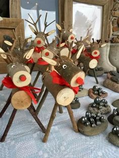 several wooden reindeer figurines sitting on top of a table next to some rocks